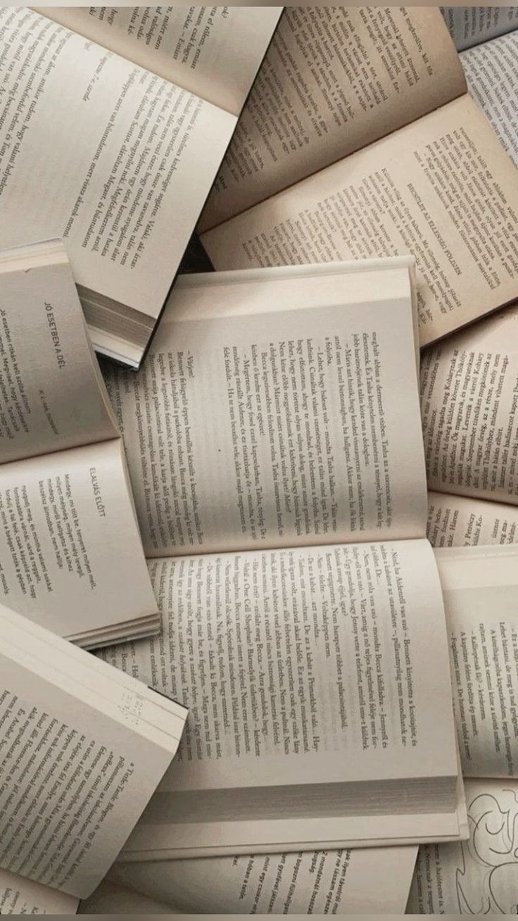 Several open books arranged together, pages facing upward