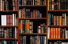 Shelves densely filled with hardback books